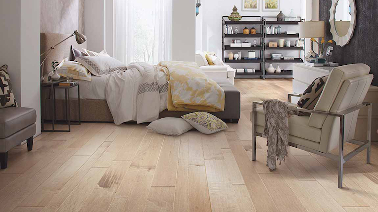 wide planked hardwood flooring in a bright and spacious bedroom